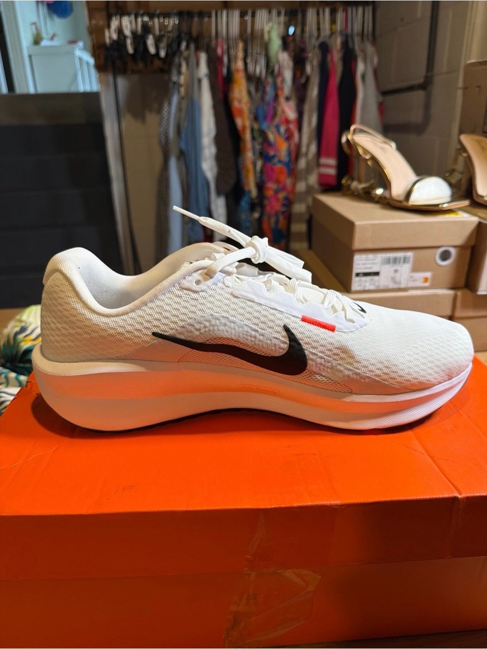 Nike White Running Shoe with Black Swoosh and Orange Accent